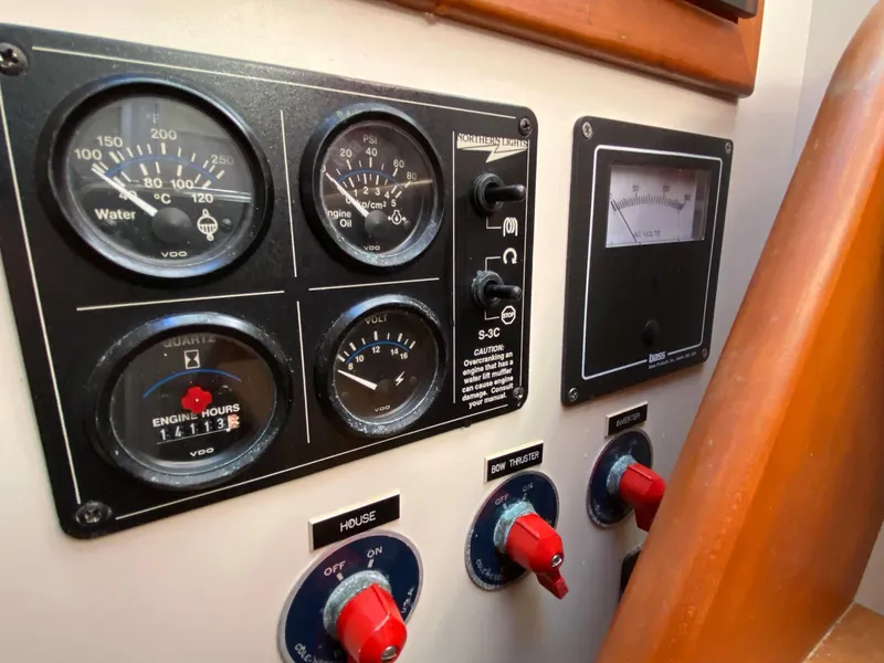 Slide: The Image of Control panel of a 2000 Little Harbor 42 Whisper Jet boat with gauges and switches. - 38