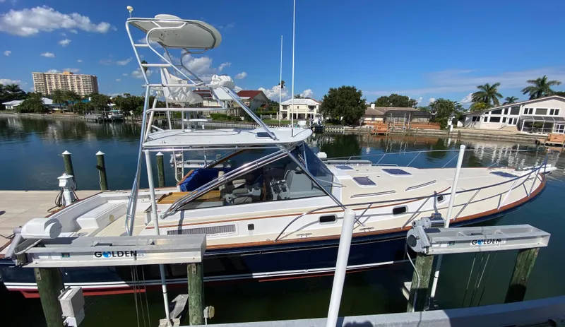 Slide: The Image of 2000 Little Harbor 42 Whisper Jet docked in a marina on a sunny day. - 5