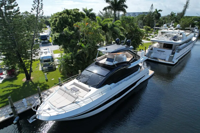 Slide: The Image of 2024 Astondoa Flybridge yacht docked in a lush, tropical marina. - 3