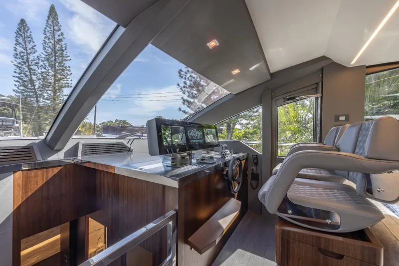 Slide: The Image of 2024 Astondoa Flybridge yacht helm station with modern controls and panoramic windows. - 39