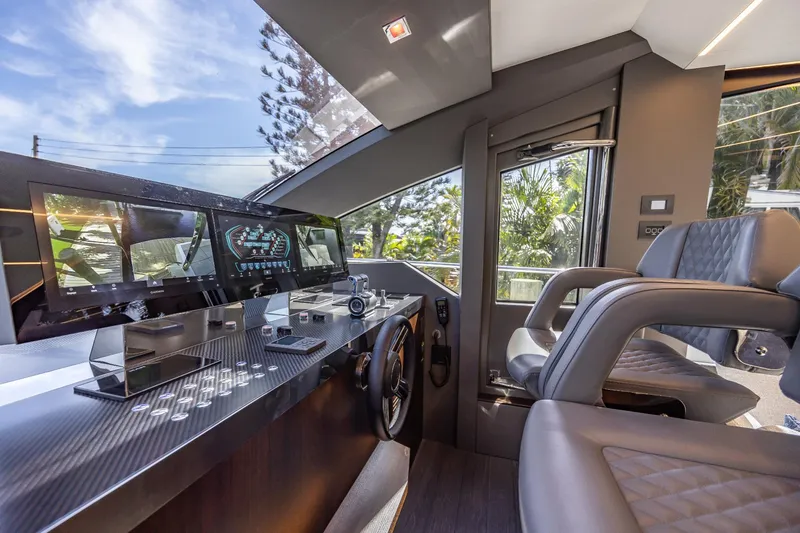 Slide: The Image of 2024 Astondoa Flybridge yacht cockpit with modern navigation system and luxurious seating. - 40