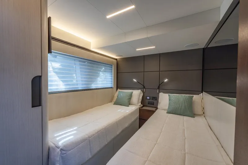 Slide: The Image of 2024 Astondoa Flybridge twin bedroom with modern design and ambient lighting. - 48
