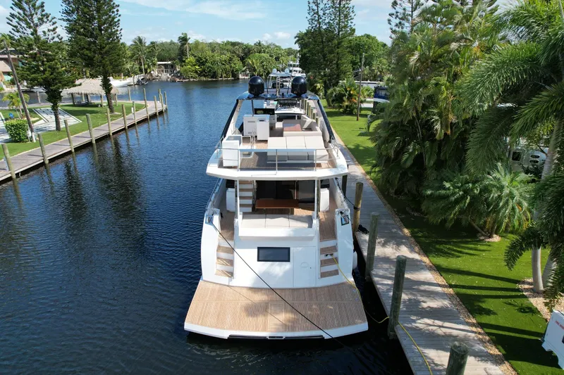 Slide: The Image of 2024 Astondoa Flybridge yacht docked in a scenic marina. - 8