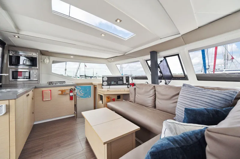 Slide: The Image of Interior of 2018 Fountaine Pajot Lucia 40 catamaran with modern seating and navigation area. - 34