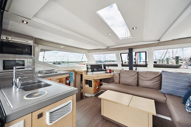 Slide: The Image of Interior of 2018 Fountaine Pajot Lucia 40 catamaran with modern kitchen and seating area. - 4