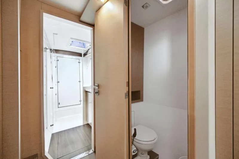 Slide: The Image of 2018 Fountaine Pajot Lucia 40 yacht bathroom interior with modern design and wooden accents. - 42