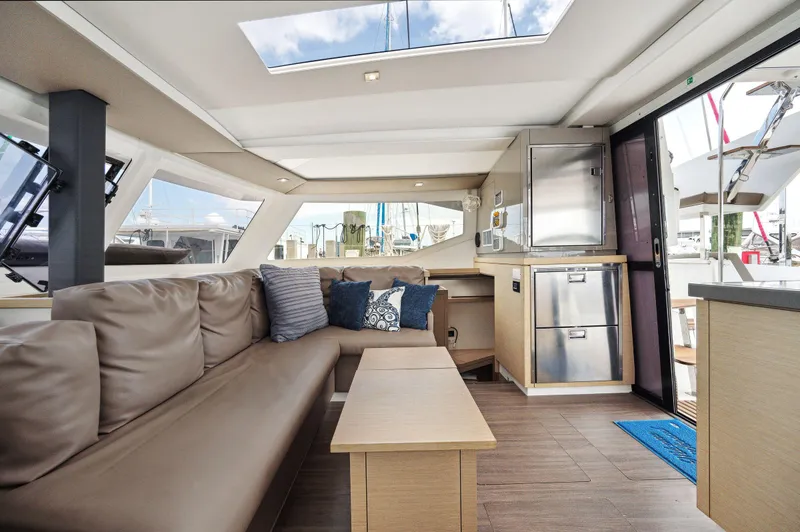 Slide: The Image of Interior of 2018 Fountaine Pajot Lucia 40 catamaran, featuring modern seating and kitchen area. - 8