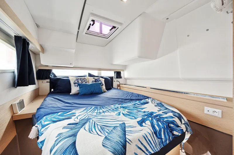 Slide: The Image of Luxurious cabin interior of 2018 Fountaine Pajot Lucia 40 catamaran with blue bedding. - 9