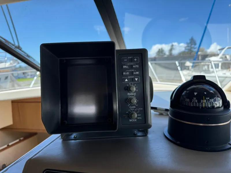 Slide: The Image of Control panel and compass on 2000 Bayliner 3388 Motor Yacht dashboard. - 14