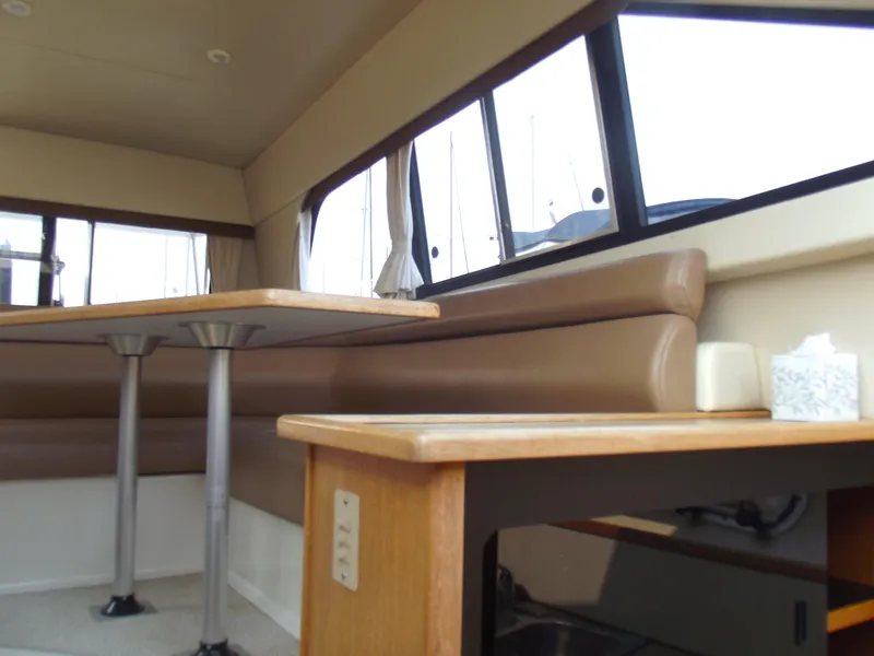 Slide: The Image of Interior of 2000 Bayliner 3388 Motor Yacht with seating and table. - 15