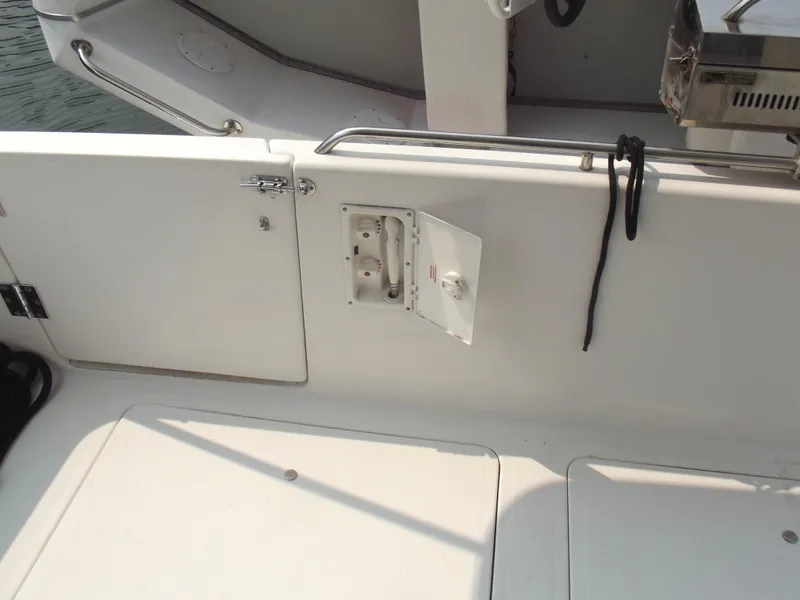 Slide: The Image of 2000 Bayliner 3388 Motor Yacht deck with storage compartment and railing. - 2