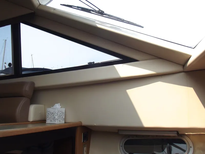 Slide: The Image of Interior view of 2000 Bayliner 3388 Motor Yacht, featuring windows and seating area. - 22