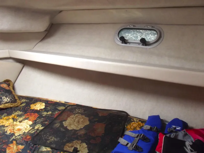 Slide: The Image of Cozy cabin interior of 2000 Bayliner 3388 Motor Yacht with floral bedding and life jackets. - 24