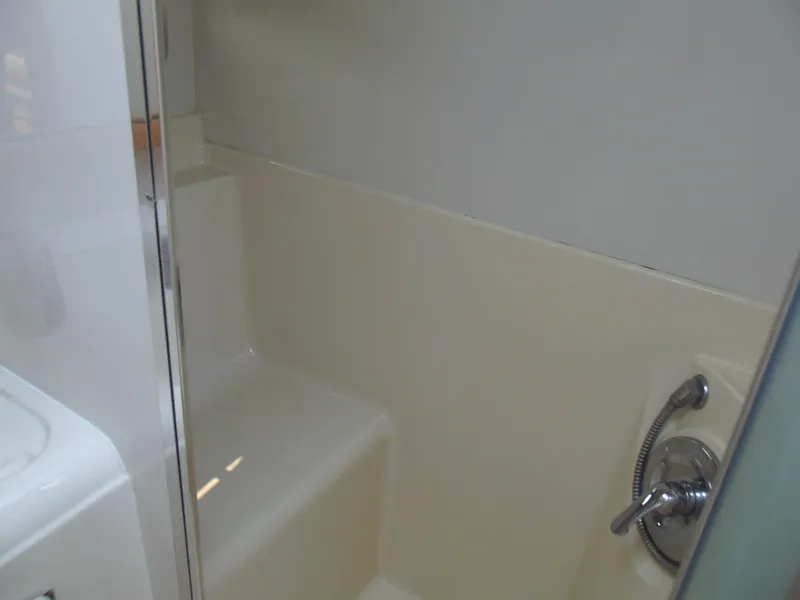 Slide: The Image of Bathroom interior of 2000 Bayliner 3388 Motor Yacht, featuring shower and faucet. - 26