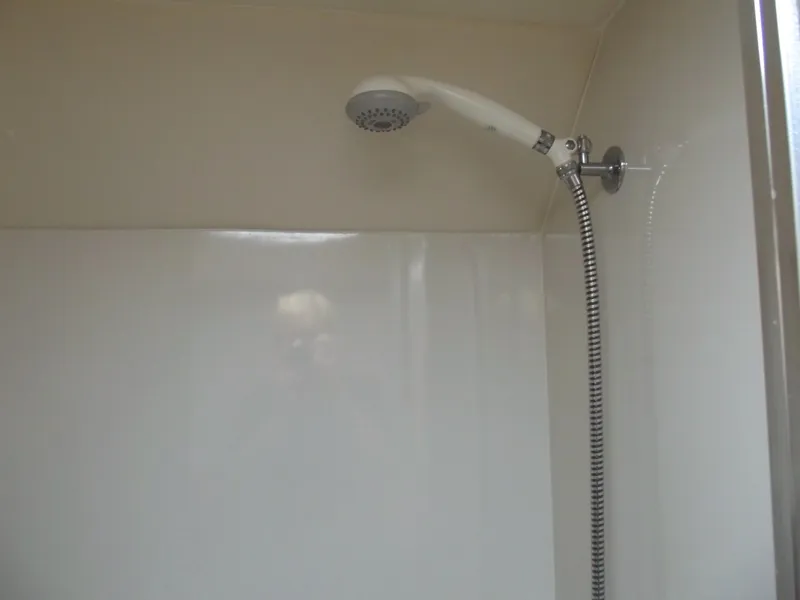 Slide: The Image of Shower area in 2000 Bayliner 3388 Motor Yacht, featuring a handheld showerhead. - 27