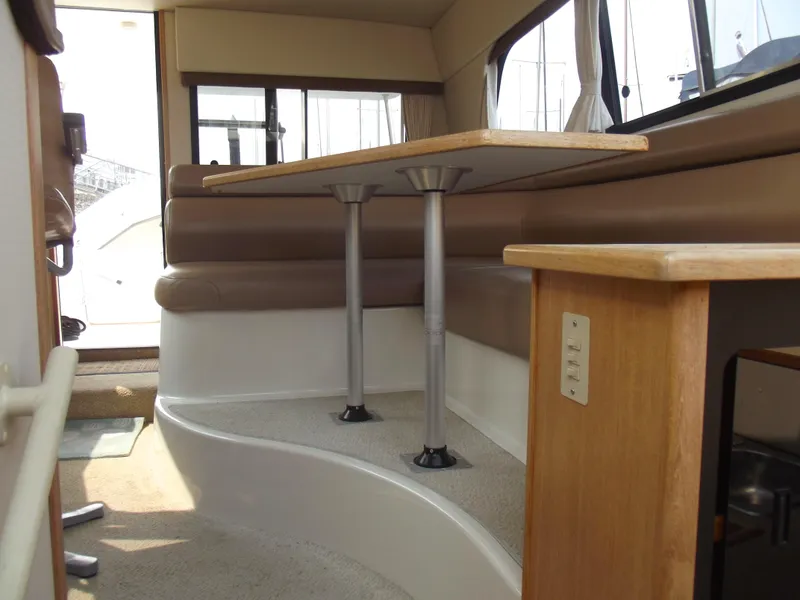 Slide: The Image of Interior of 2000 Bayliner 3388 Motor Yacht with dining area and table. - 28