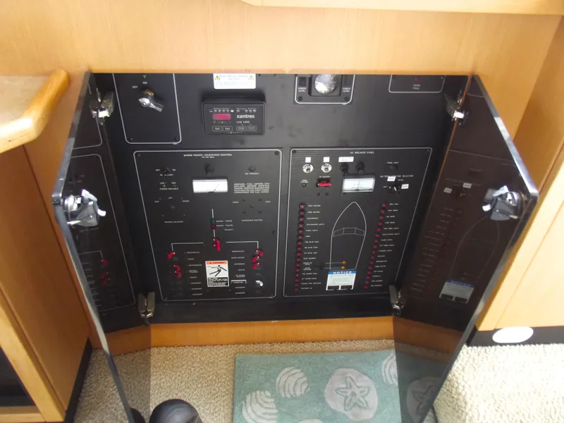 Slide: The Image of Electrical control panel of a 2000 Bayliner 3388 Motor Yacht, featuring various switches and indicators. - 30