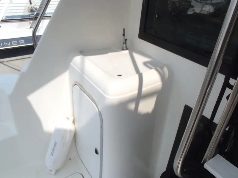 Slide: The Image of Bayliner 3388 Motor Yacht 2000, onboard sink area with storage, white finish. - 4