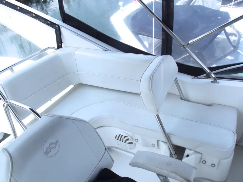 Slide: The Image of White seating area on 2000 Bayliner 3388 Motor Yacht, featuring sleek design and comfortable cushions. - 6