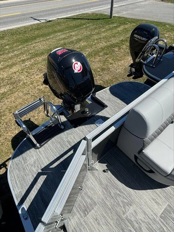 Slide: The Image of 2022 Sun Tracker PB 24 DLX pontoon boat with dual Mercury outboard motors. - 11