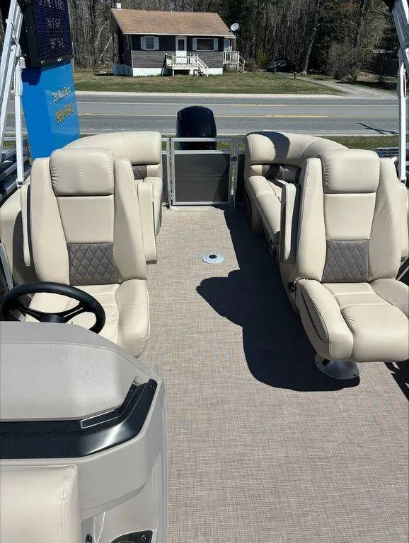 Slide: The Image of 2022 Sun Tracker PB 24 DLX pontoon boat with beige seating and spacious deck. - 8