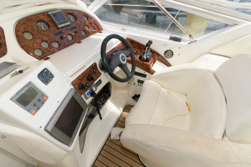 Slide: The Image of Cockpit of a 2005 Cranchi 37 Smeraldo yacht with steering wheel and control panel. - 5
