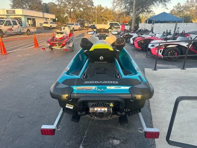 Slide: The Image of 2024 Sea-Doo Waverunner GTI with vibrant seat, parked on sandy ground. - 5