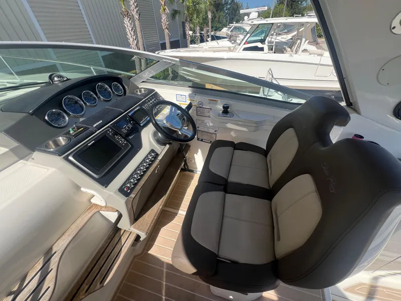 Slide: The Image of 2014 Sea Ray 350 Sundancer helm with dual seating and modern dashboard. - 11