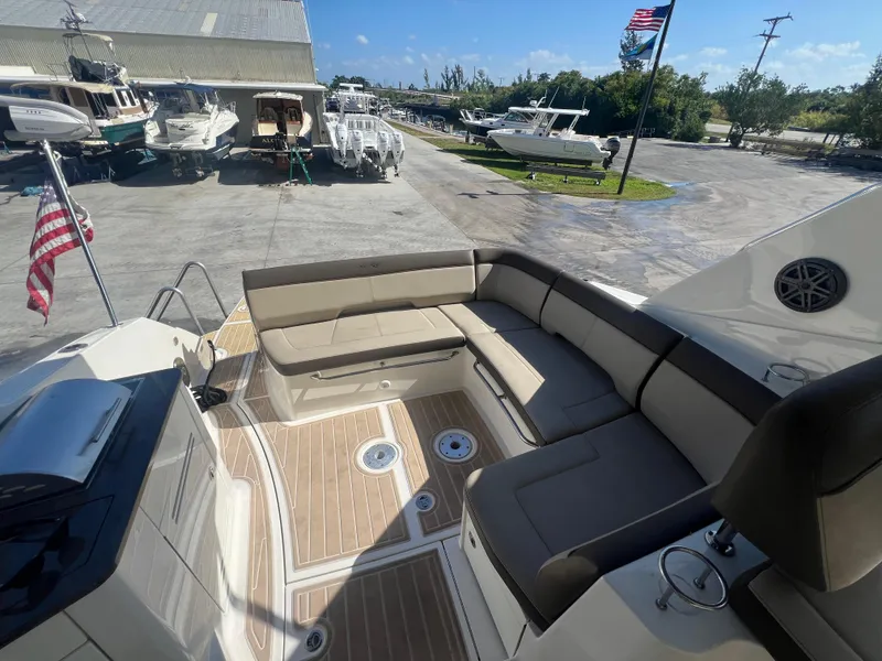 Slide: The Image of 2014 Sea Ray 350 Sundancer boat with spacious seating area and American flag. - 19