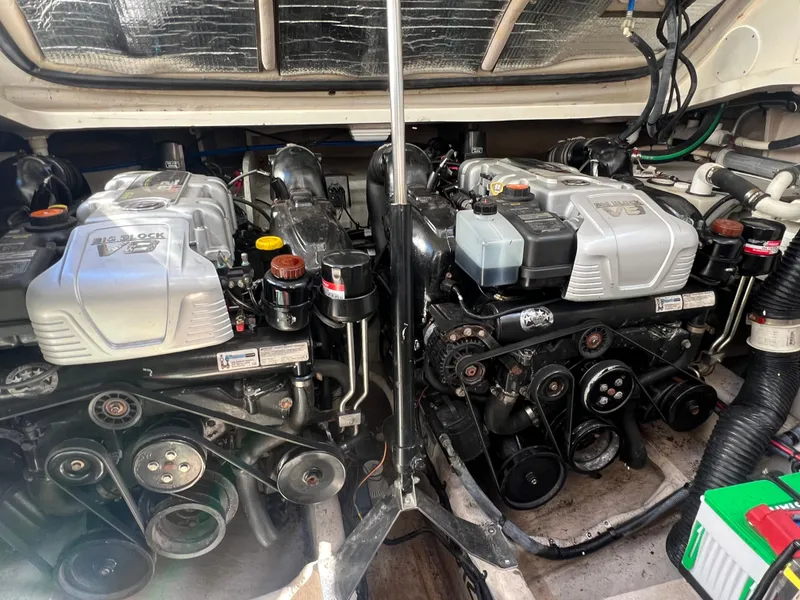 Slide: The Image of 2014 Sea Ray 350 Sundancer engine compartment with twin engines and mechanical components. - 24