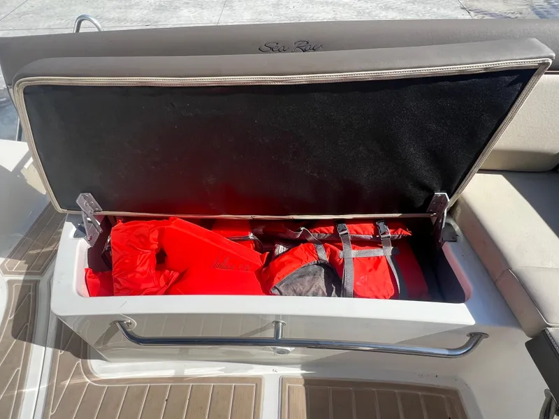 Slide: The Image of Storage compartment with life jackets on a 2014 Sea Ray 350 Sundancer boat. - 28