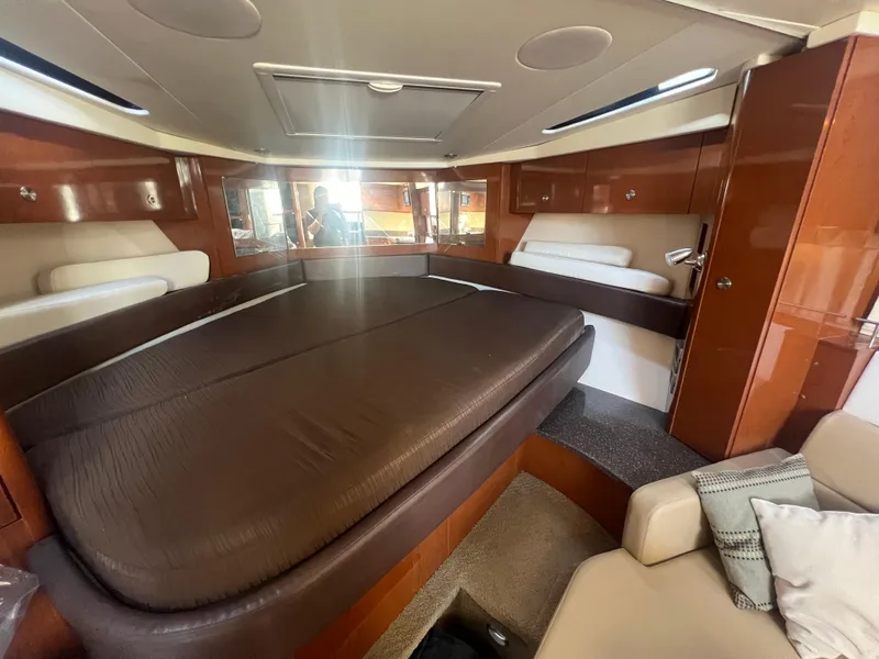 Slide: The Image of Interior cabin of 2014 Sea Ray 350 Sundancer with bed and seating area. - 32