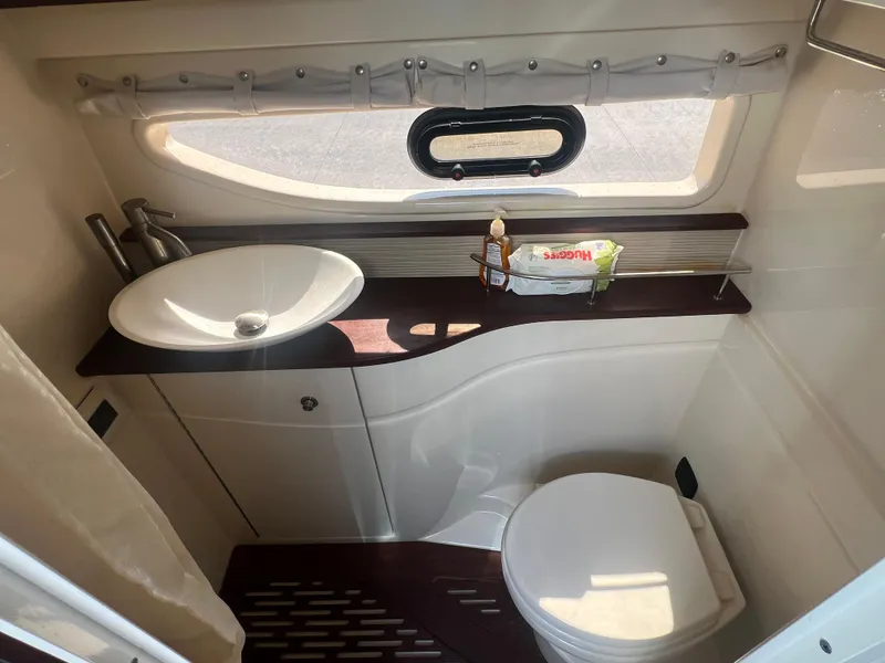 Slide: The Image of 2014 Sea Ray 350 Sundancer bathroom with sink, toilet, and window. - 35