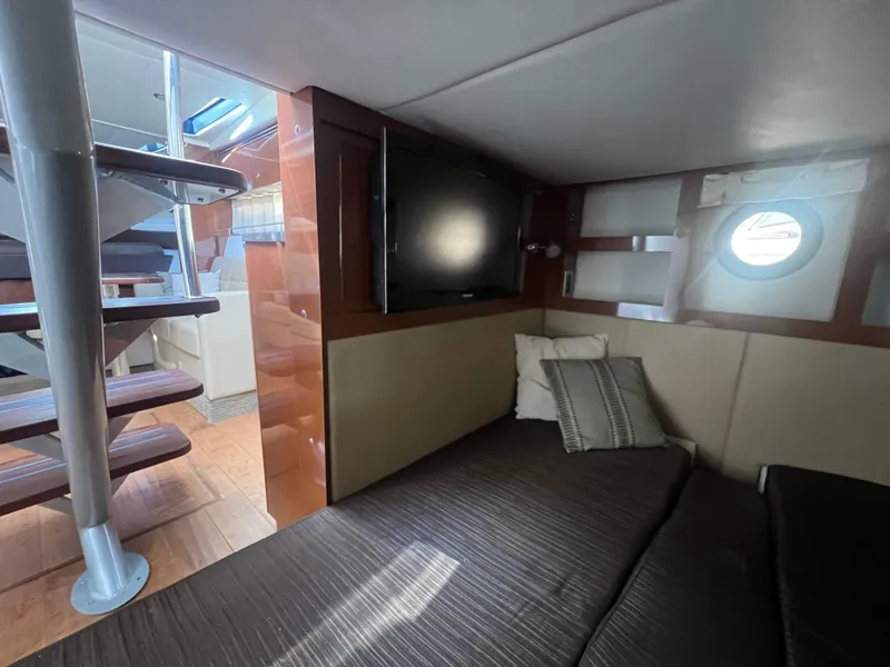 Slide: The Image of 2014 Sea Ray 350 Sundancer cabin interior with TV and staircase. - 36