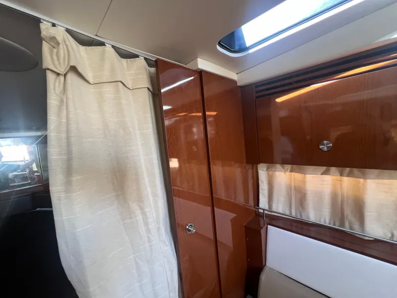 Slide: The Image of Interior cabin of 2014 Sea Ray 350 Sundancer with wooden cabinetry and curtain. - 40