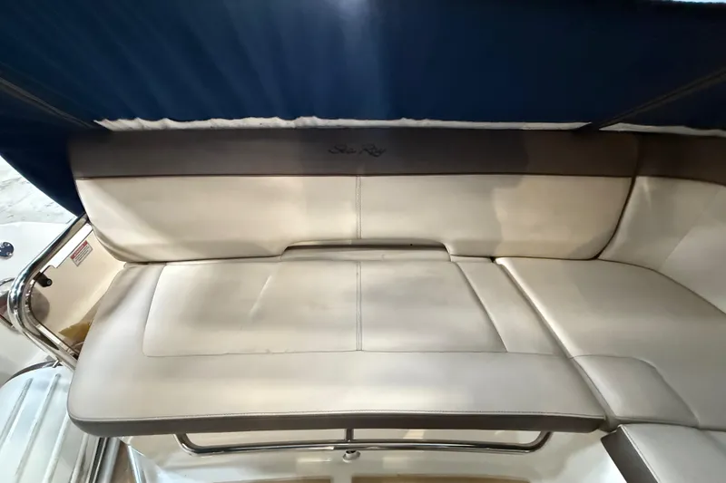 Slide: The Image of 2014 Sea Ray Sundancer 350 boat interior with cushioned seating and blue canopy. - 49