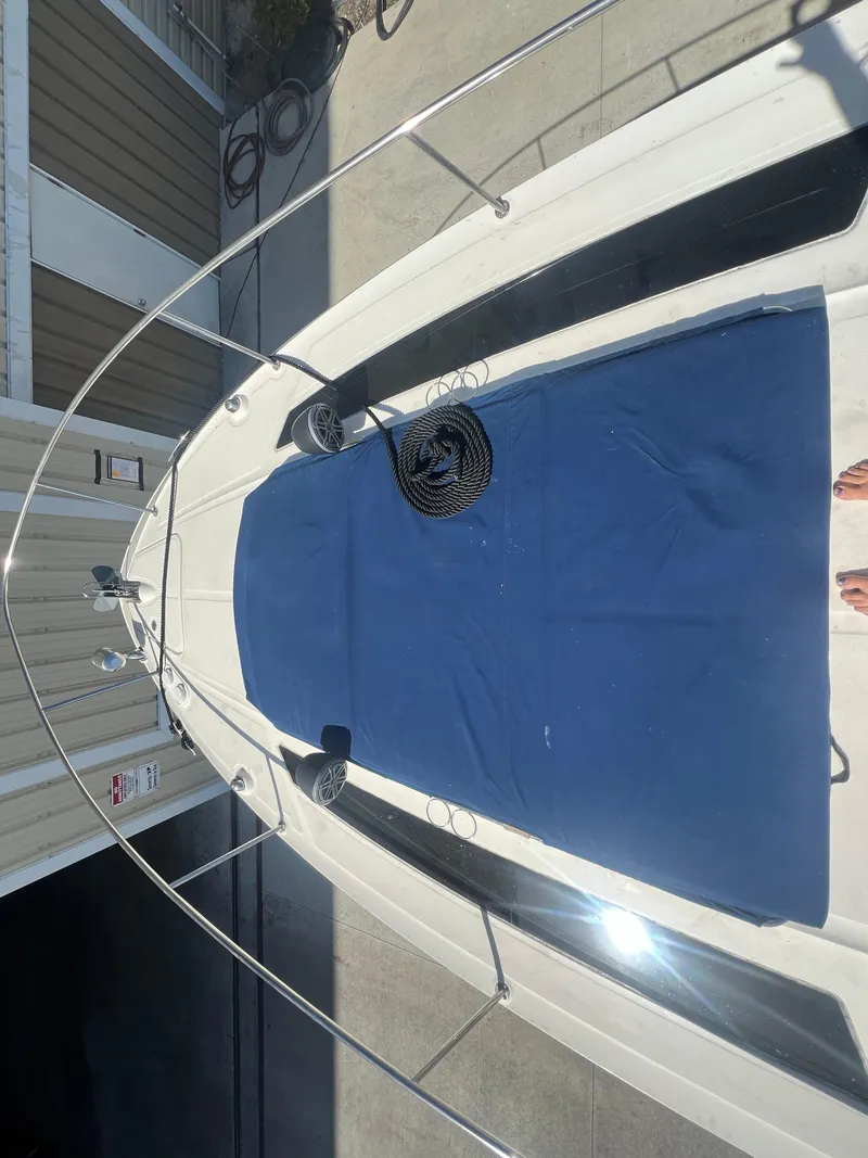 Slide: The Image of 2014 Sea Ray 350 Sundancer boat deck with blue cover. - 7