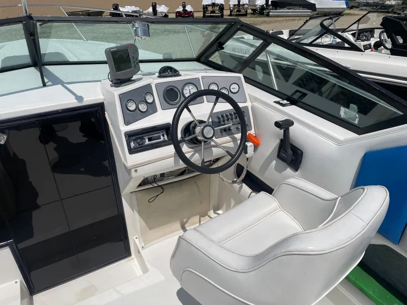 Slide: The Image of 1995 Sport-Craft 2500 AVANZA boat cockpit with steering wheel and control panel. - 6