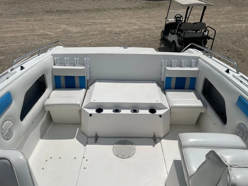 Slide: The Image of 1995 Sport-Craft 2500 AVANZA boat interior with seating and rod holders. - 7