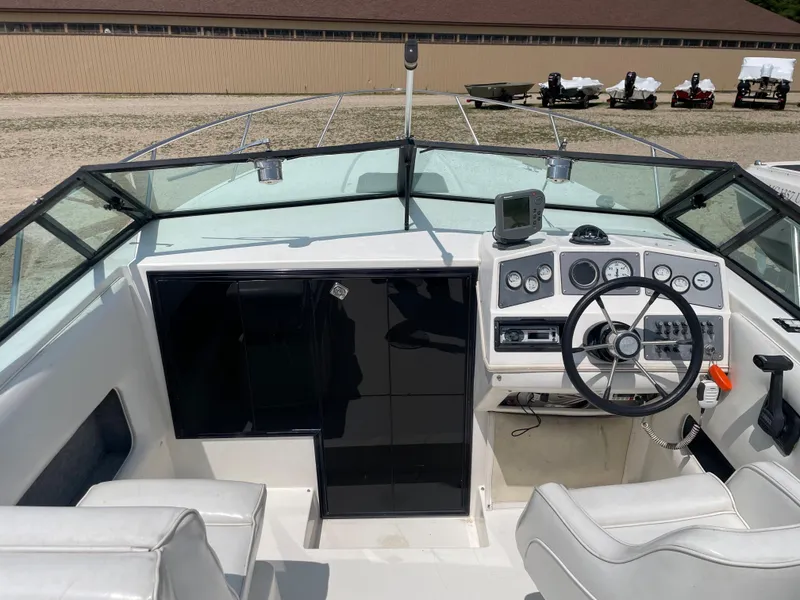 Slide: The Image of 1995 Sport-Craft 2500 AVANZA boat cockpit with steering wheel and control panel. - 9