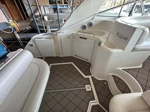 Slide: The Image of 2000 Cruisers 3870 yacht interior with white seating and modern amenities. - 2