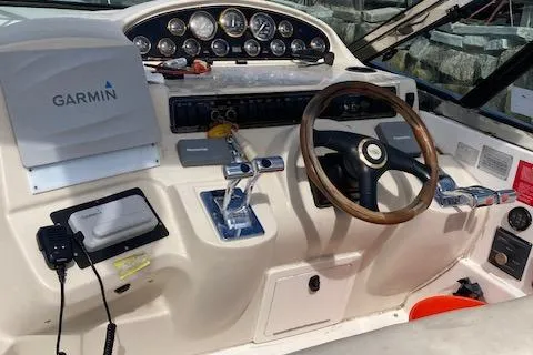 Slide: The Image of Cockpit of 2000 Cruisers 3870 boat with Garmin navigation system and wooden steering wheel. - 9