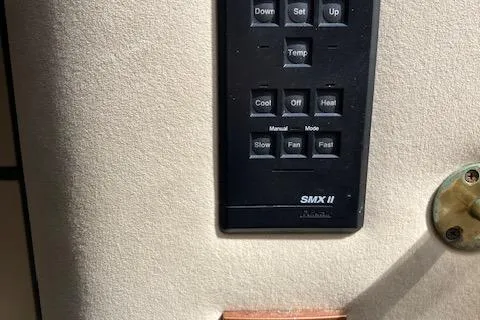 Slide: The Image of Control panel of a 2000 Cruisers 3870 boat, featuring temperature and fan settings. - 11