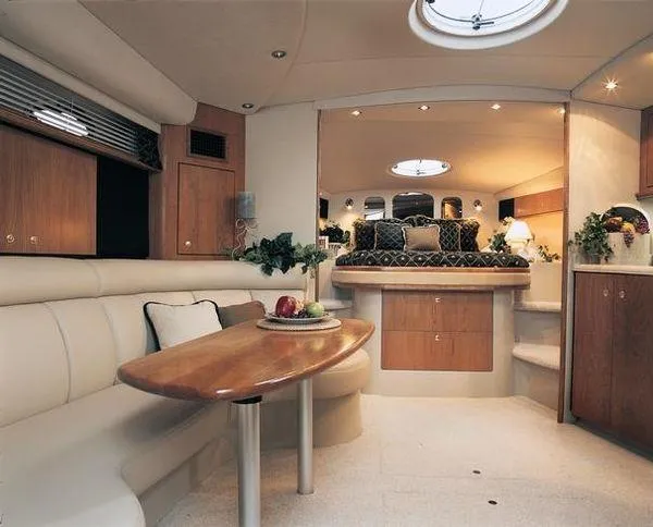 Slide: The Image of Luxurious interior of 2000 Cruisers 3870 yacht with elegant seating and dining area. - 3