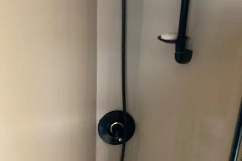 Slide: The Image of Shower fixture inside a 2000 Cruisers 3870 boat, featuring a sleek black design. - 6