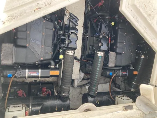 Slide: The Image of Engine compartment of a 2000 Cruisers 3870 boat, showcasing dual engines and mechanical components. - 8