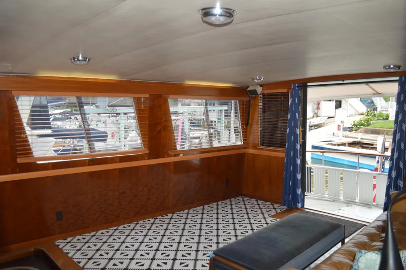 Slide: The Image of Interior of 1986 Gulfstar 49 Motor Yacht with large windows and patterned flooring. - 10