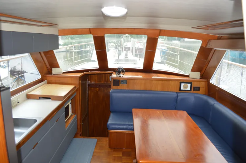 Slide: The Image of Interior of 1986 Gulfstar 49 Motor Yacht with kitchen and dining area. - 11