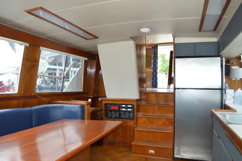 Slide: The Image of Interior of 1986 Gulfstar 49 Motor Yacht with dining area and kitchen. - 12