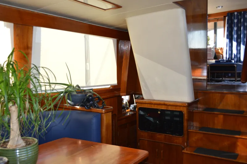 Slide: The Image of Interior of 1986 Gulfstar 49 Motor Yacht with wooden furnishings and potted plant. - 13